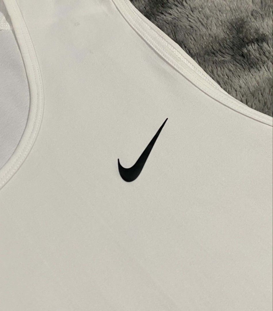Nike Dri-FIT White Training Tank Top Size L (Category: Activewear) located in Sorsogon. Submitted by johnmichae69459 (Listing ID 1470679836, Image 3). Description: - Brand: Nike - Item: Men's Training Tank Top - Color: Crisp White - Size: Large - 22 width - 28 lenght - Material: 100% Dri-FIT Polyester (keeps you cool and dry) - Design: Classic sleeveless cut, crew neckline, and small black Nike swoosh on left chest - Origin: Made in China - Condi