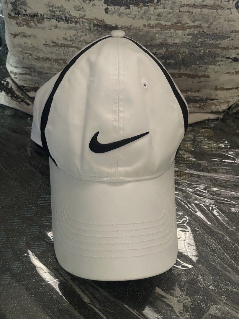 Nike Golf White Cap with Black Piping (Category: Caps & Hats) located in Angeles City. Submitted by lukemafinds (Listing ID 1470598463, Image 1). Description: - Brand: Nike Golf - Color: White with black piping details - Logos: Embroidered Swoosh on front and back - Fit: Adjustable velcro strap, one size fits most - Origin: Made in Vietnam - Versatile for sports or daily casual wear -original -good for golfing and pamorma -699 only.