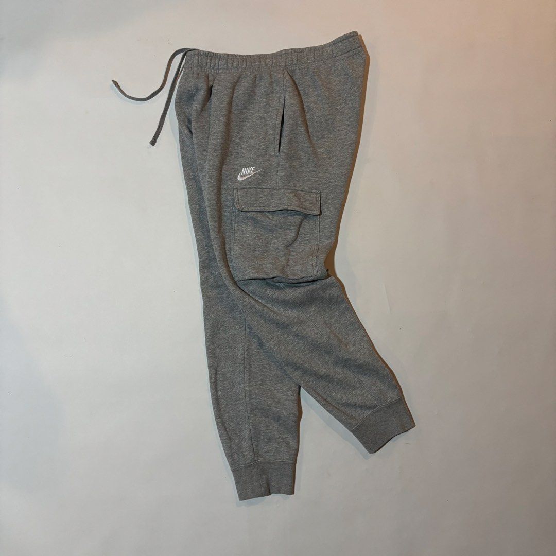 Nike Grey Cargo Sweatpants Joggers Size M (Category: Joggers) located in Dipolog. Submitted by dionato (Listing ID 1470666479, Image 1). Description: - Brand: Nike - Item: Cargo sweatpants - Color: Grey - Size: Men's Medium - Material: Super comfortable fleece - Features: Elastic waistband with adjustable drawstring, side pockets, utility cargo pockets on both legs, and cuffed ankles - Branding: Embroidered white Nike logo on the left leg - Condi
