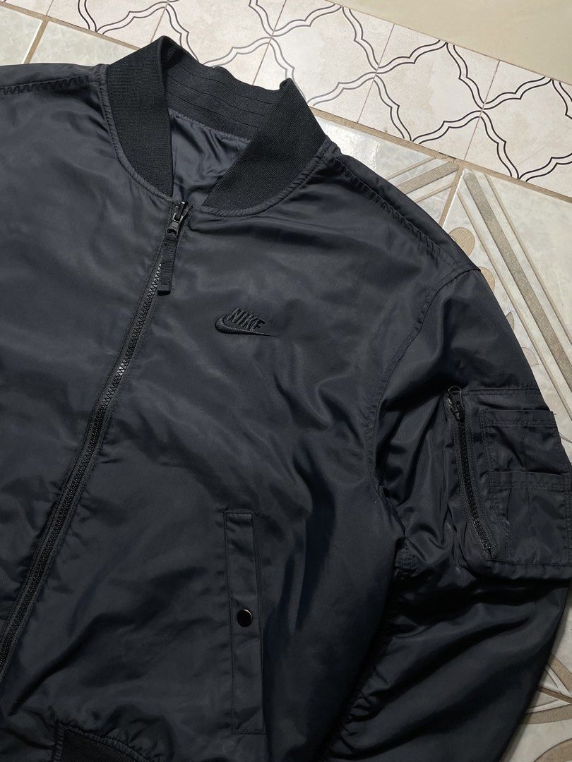 Nike Insulated Reversible Bomber Jacket (Category: Coats, Jackets and Outerwear) located in Quezon City. Submitted by renovare.196 (Listing ID 1470656326, Image 3). Description: Nike Insulated Reversible Bomber Jacket Excellent Condition Color Rate: 9.8/10 Issue: Not visible stain Authentic/Legit Measurements • Width: 23 • Length: 25 Price: 1500 obo DM IF INTERESTED📥.