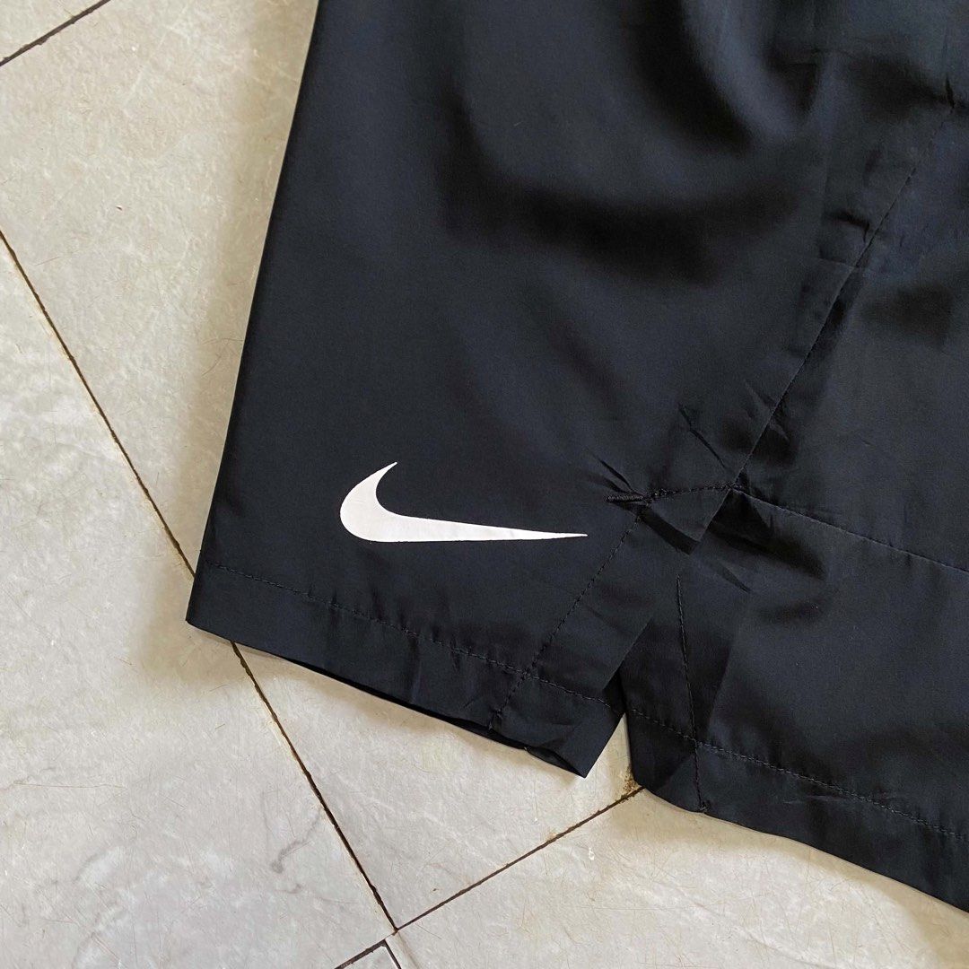Nike Men's Black Athletic Shorts with Drawstring (Category: Shorts) located in Butuan. Submitted by jc13thrifts (Listing ID 1470617324, Image 3). Description: - Brand: Nike - Color: Classic Black with White Swoosh logo - Material: Lightweight, breathable fabric ideal for workouts and running - Waistband: Elastic with printed Nike branding and adjustable black drawstring - Pockets: Deep side pockets with mesh lining - Condition: Excellent - Issue: