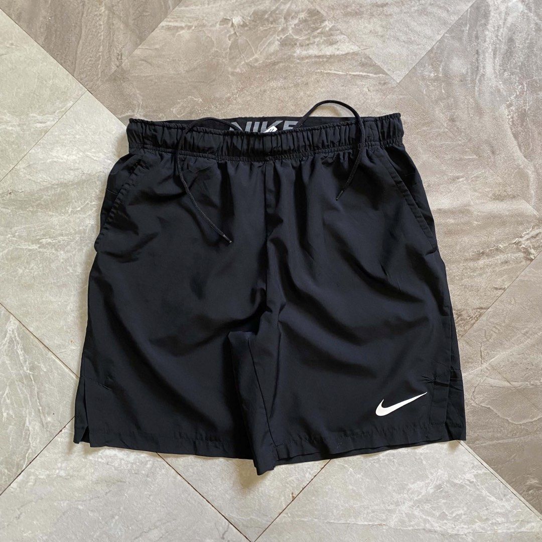 Nike Men's Black Athletic Shorts with Drawstring (Category: Shorts) located in Butuan. Submitted by jc13thrifts (Listing ID 1470617324, Image 1). Description: - Brand: Nike - Color: Classic Black with White Swoosh logo - Material: Lightweight, breathable fabric ideal for workouts and running - Waistband: Elastic with printed Nike branding and adjustable black drawstring - Pockets: Deep side pockets with mesh lining - Condition: Excellent - Issue: