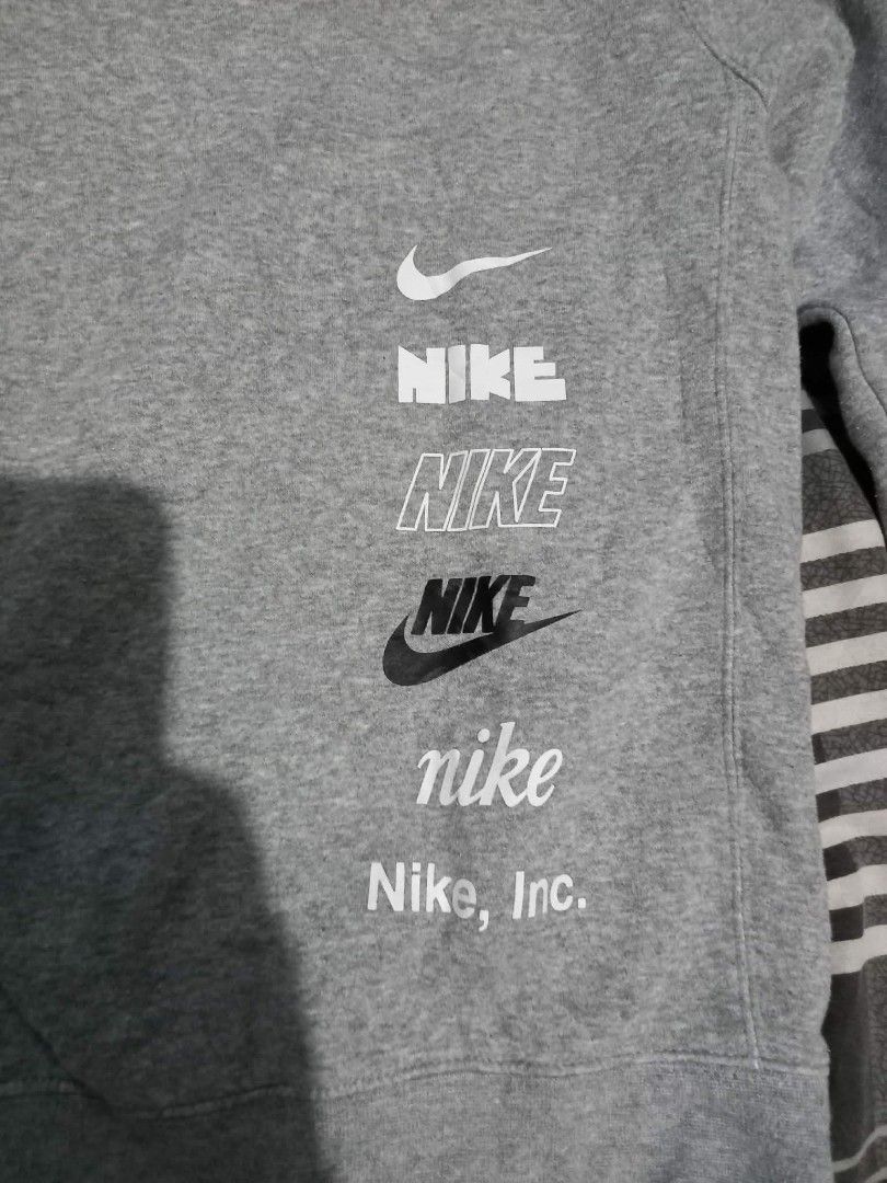 Nike Multi Logo Grey Sweatshirt Size S (Category: Coats, Jackets and Outerwear) located in Panabo. Submitted by khimmyirish_ki021126 (Listing ID 1470581592, Image 1). Description: - Brand: Nike - Style: Crewneck pullover sweatshirt - Color: Grey - Size: S (Measures approx. 23-24 inches across) - Material: 80% Cotton, 20% Polyester - Design: Multiple stacked logo prints on the bottom front - Origin: Made in Malaysia - Condition: Great for comforta