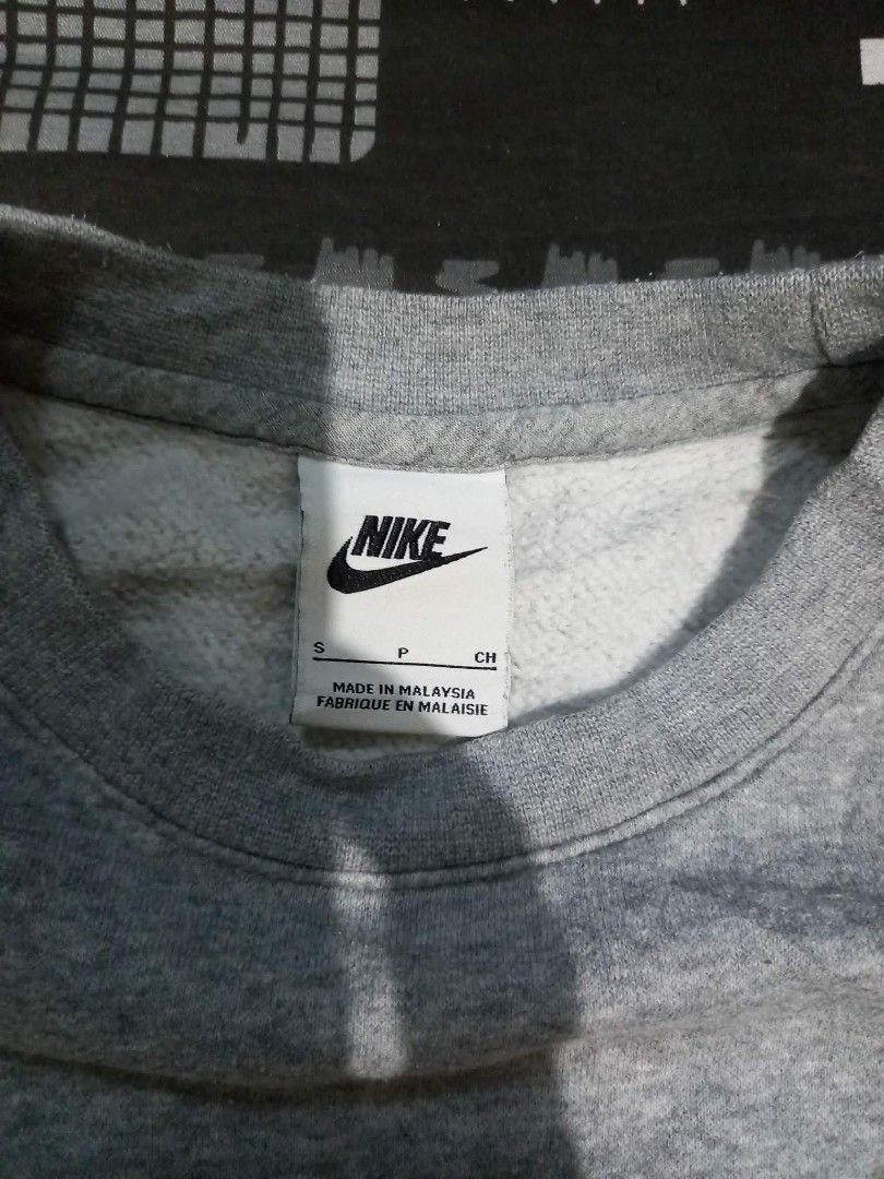 Nike Multi Logo Grey Sweatshirt Size S (Category: Coats, Jackets and Outerwear) located in Panabo. Submitted by khimmyirish_ki021126 (Listing ID 1470581592, Image 3). Description: - Brand: Nike - Style: Crewneck pullover sweatshirt - Color: Grey - Size: S (Measures approx. 23-24 inches across) - Material: 80% Cotton, 20% Polyester - Design: Multiple stacked logo prints on the bottom front - Origin: Made in Malaysia - Condition: Great for comforta
