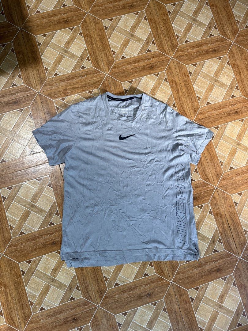 Nike Pro Grey Athletic T-Shirt (Category: Activewear) located in Siniloan. Submitted by jaylmagbuo (Listing ID 1470602176, Image 1). Description: - Brand: Nike Pro - Color: Grey - Style: Short sleeve athletic t-shirt with crew neck - Fit: Regular training fit - Technology: Dri-FIT moisture-wicking fabric - Details: Small black swoosh logo on chest and bold Nike Pro text on lower left side - Condition: Excellent.