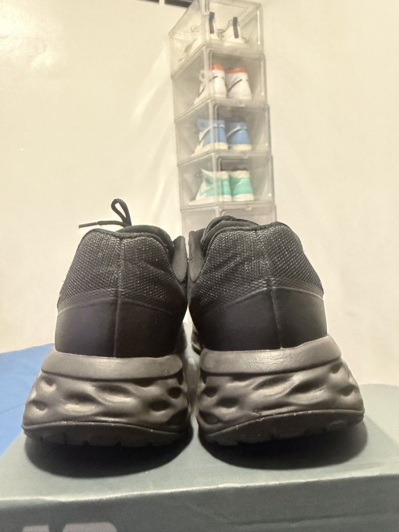 Nike Revolution 6 Black Running Shoes (Category: Sneakers) located in Manila. Submitted by riyhun (Listing ID 1470696036, Image 3). Description: - Brand: Nike - Color: All-Black - Size: US 12.5 / UK 11.5 / EUR 47 - Material: Breathable mesh upper with cushioned foam sole - Condition: Excellent, clean uppers with minimal tread wear - Ideal for: Running, gym sessions, and daily wear - Fit: Standard lace-up.