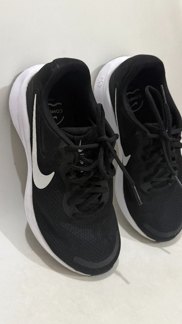 Nike Revolution Black White Running Shoes (Category: Sneakers) located in Makati City. Submitted by joy.oriioo (Listing ID 1470592963, Image 2). Description: - Brand: Nike - Size: US 7.5 Womens - Color: Black with crisp white soles and classic swoosh logo - Material: Breathable mesh upper with cushioned insoles - Condition: Minimal wear around the edges, laces included - Best For: Gym workouts, running, or casual daily walks.