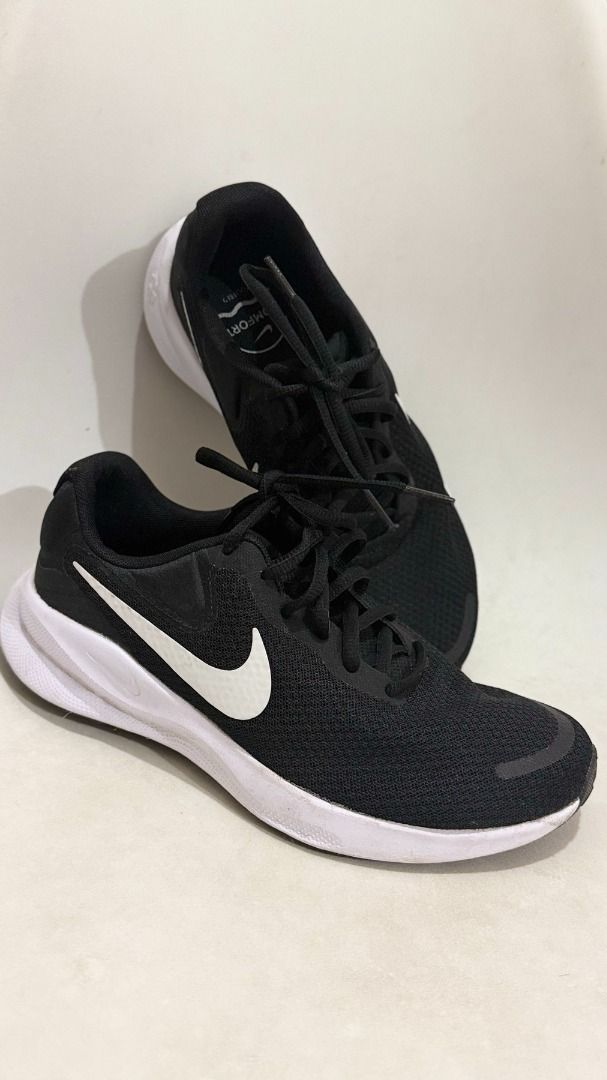 Nike Revolution Black White Running Shoes (Category: Sneakers) located in Makati City. Submitted by joy.oriioo (Listing ID 1470592963, Image 3). Description: - Brand: Nike - Size: US 7.5 Womens - Color: Black with crisp white soles and classic swoosh logo - Material: Breathable mesh upper with cushioned insoles - Condition: Minimal wear around the edges, laces included - Best For: Gym workouts, running, or casual daily walks.