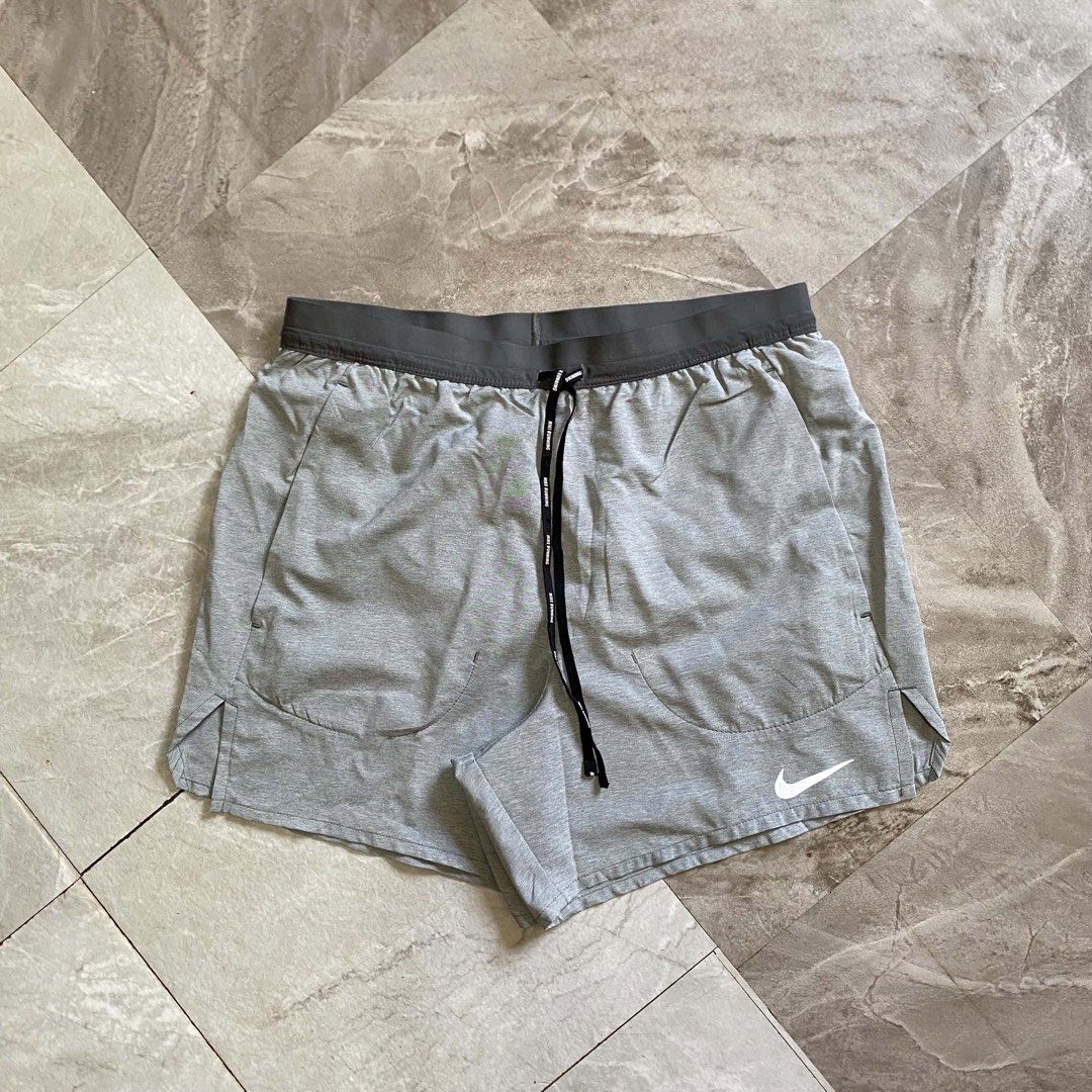 Nike Running Shorts Grey (Category: Shorts) located in Butuan. Submitted by jc13thrifts (Listing ID 1470617277, Image 1). Description: - Authentic Nike grey running shorts - Elastic waistband with branded black drawstring - White Nike swoosh logo on the lower left leg and side hems - Dark grey back panels featuring mesh pockets and a secure zipped pocket - Lightweight, breathable fabric ideal for gym, running, and workouts - Condition: Excellent 