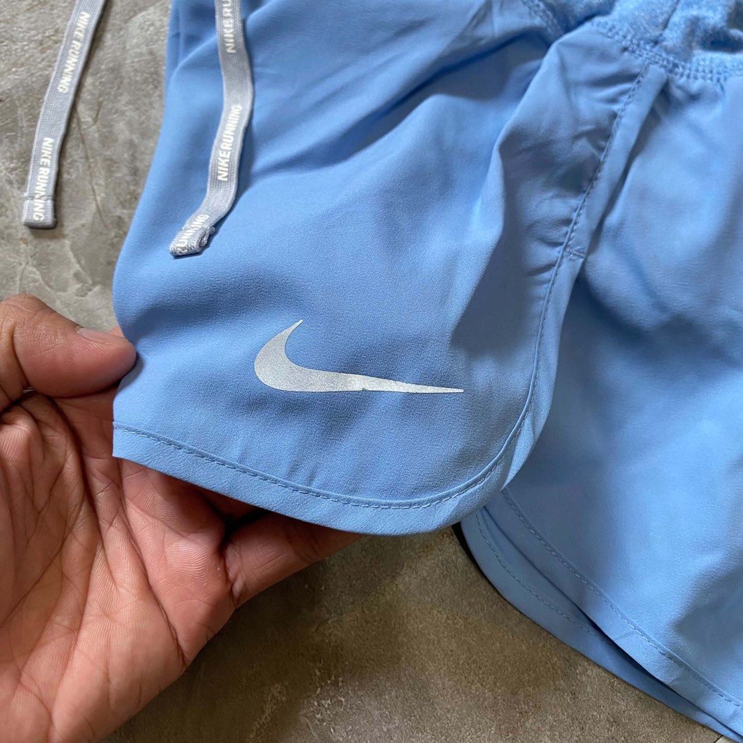 Nike Running Shorts Light Blue (Category: Shorts) located in Butuan. Submitted by jc13thrifts (Listing ID 1470617206, Image 3). Description: - Light blue Nike running shorts, great for workouts and jogs - Wide heather blue waistband with Nike Running text drawstrings - Convenient back zippered pocket for cards and keys - Reflective Swoosh logo for visibility - Lightweight, breathable material.