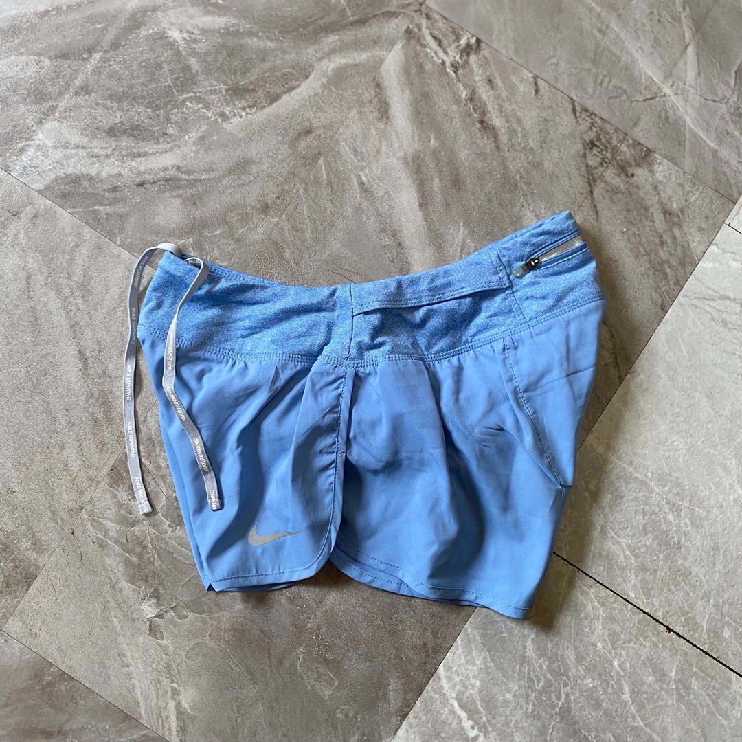 Nike Running Shorts Light Blue (Category: Shorts) located in Butuan. Submitted by jc13thrifts (Listing ID 1470617206, Image 2). Description: - Light blue Nike running shorts, great for workouts and jogs - Wide heather blue waistband with Nike Running text drawstrings - Convenient back zippered pocket for cards and keys - Reflective Swoosh logo for visibility - Lightweight, breathable material.
