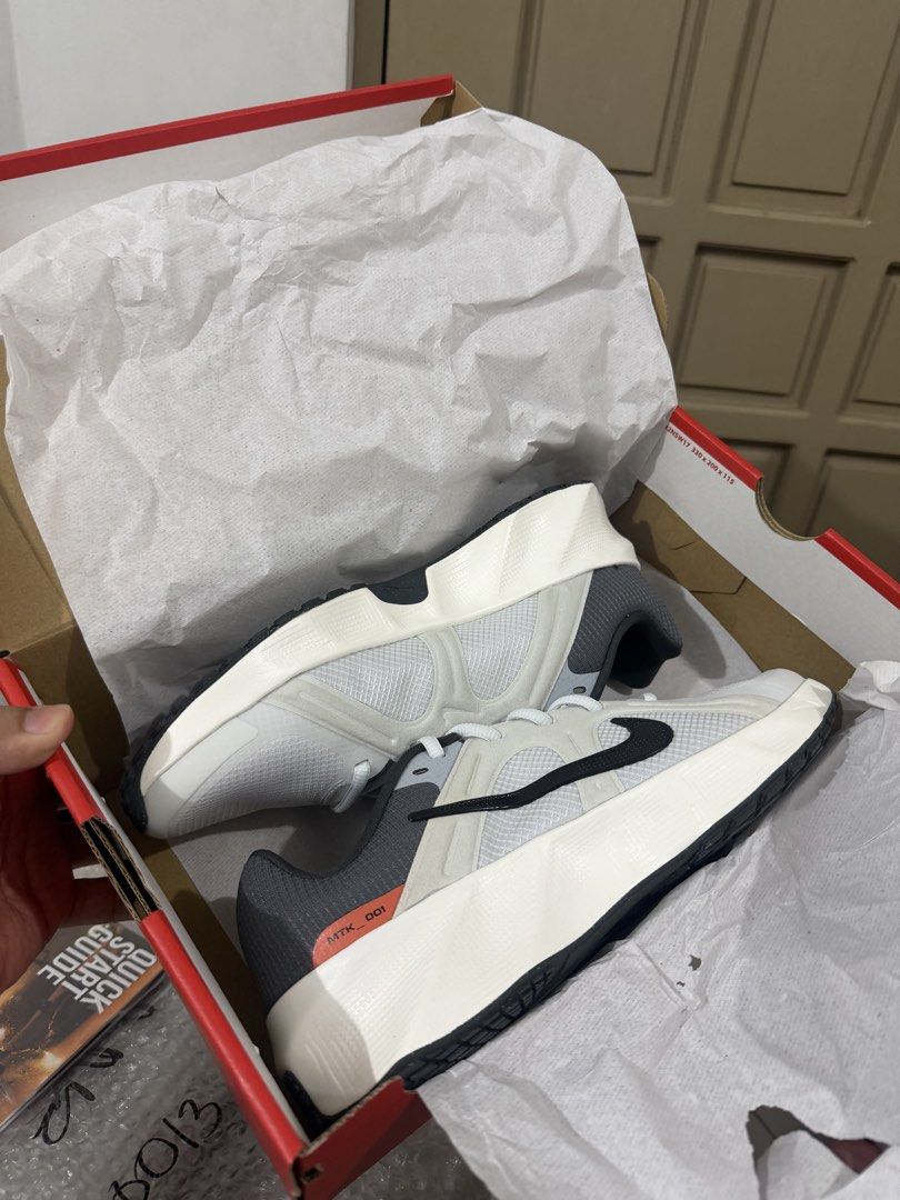Nike sneakers in white and black (Category: Sneakers) located in Marikina City. Submitted by epicdog_9746d4 (Listing ID 1470595905, Image 1). Description: - Brand: Nike - Color: White, black, and grey with orange accents - Condition: Brand new, never worn, clean - Features: Breathable mesh upper, bold swoosh branding, thick chunky midsole, black rubber outsole, and MTK 001 heel tab - Packaging: Comes in original Nike red shoebox with packing pape