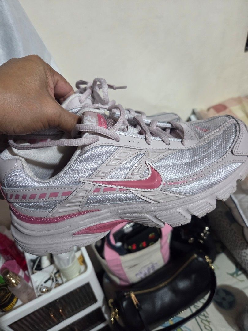Nike Sneakers Pink Size US 6.5 (Category: Sneakers) located in Manila. Submitted by analiepagl91301 (Listing ID 1470675345, Image 1). Description: - Brand: Nike - Color: Light Pink - Size: US Women's 6.5 - Style Code: 394053-009 - Material: Breathable mesh upper with a comfortable padded collar - Insole: Pink cushioned insole with classic white Nike swoosh logo - Condition: Clean interior, well-maintained, and ready to wear.