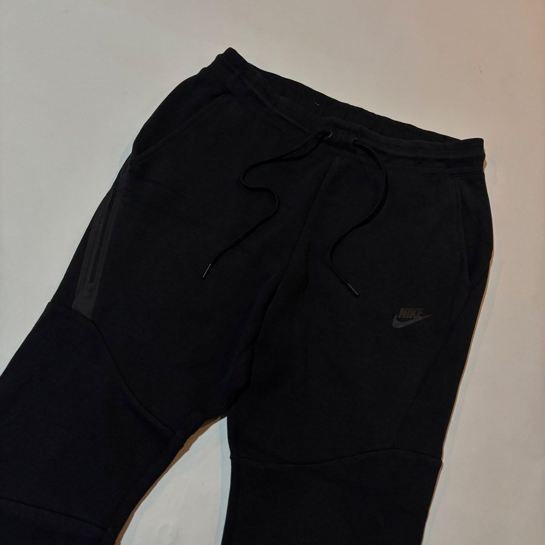 Nike Tech Fleece Black Joggers Size M (Category: Joggers) located in Dipolog. Submitted by dionato (Listing ID 1470675677, Image 3). Description: - Brand: Nike - Model: Tech Fleece Joggers - Color: Black - Size: Medium - Condition: Brand new / Excellent - Fit: Classic tapered fit with ribbed ankle cuffs - Pockets: Signature bonded zip pocket on the side - Waistband: Elastic with adjustable drawstrings - Material: Soft and comfortable cotton blend