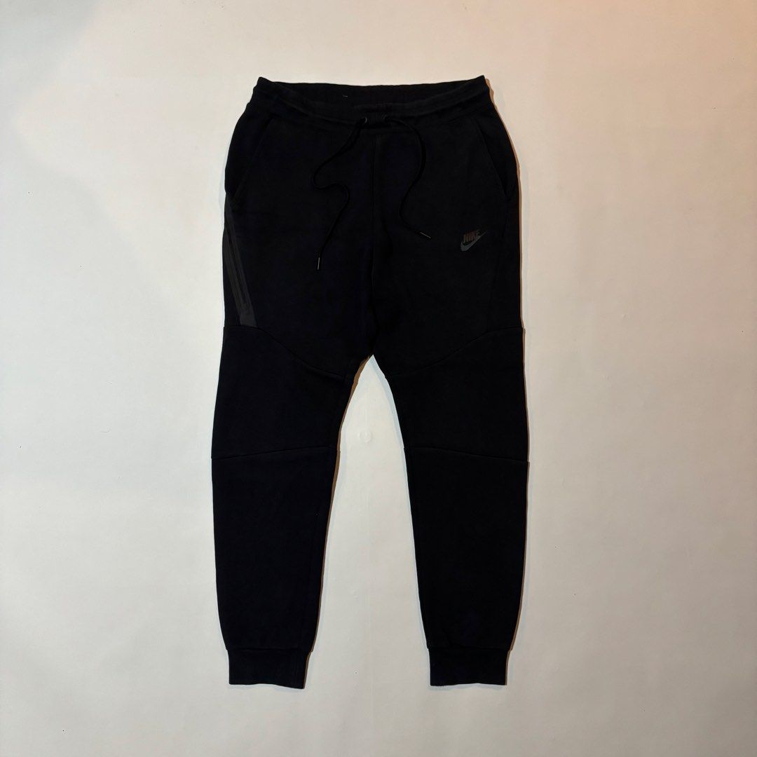 Nike Tech Fleece Black Joggers Size M (Category: Joggers) located in Dipolog. Submitted by dionato (Listing ID 1470675677, Image 2). Description: - Brand: Nike - Model: Tech Fleece Joggers - Color: Black - Size: Medium - Condition: Brand new / Excellent - Fit: Classic tapered fit with ribbed ankle cuffs - Pockets: Signature bonded zip pocket on the side - Waistband: Elastic with adjustable drawstrings - Material: Soft and comfortable cotton blend