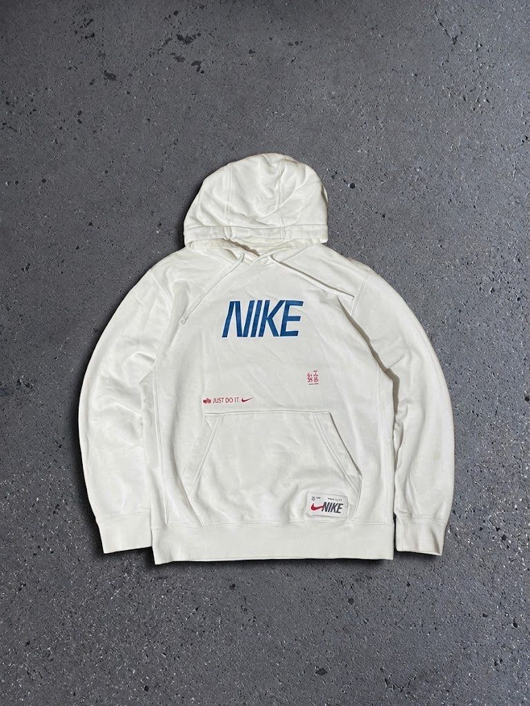 Nike White Graphic Hoodie (Category: Hoodies) located in Polangui. Submitted by thrift2house (Listing ID 1470576046, Image 1). Description: - Brand: Nike - Color: White with blue lettering and multicolored mosaic swoosh - Details: Small 'Just Do It' text and patch near the front pocket, drawstring hood - Material: Soft cotton blend - Fit: Comfortable daily wear piece - Condition: Excellent / Pre-loved (ready to ship).