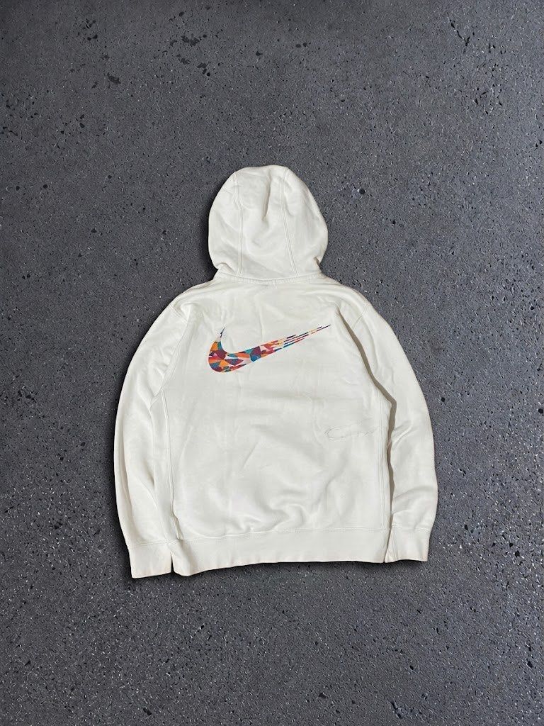 Nike White Graphic Hoodie (Category: Hoodies) located in Polangui. Submitted by thrift2house (Listing ID 1470576046, Image 2). Description: - Brand: Nike - Color: White with blue lettering and multicolored mosaic swoosh - Details: Small 'Just Do It' text and patch near the front pocket, drawstring hood - Material: Soft cotton blend - Fit: Comfortable daily wear piece - Condition: Excellent / Pre-loved (ready to ship).