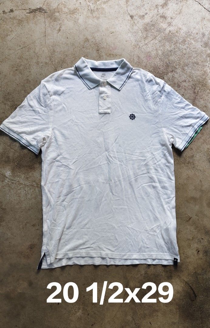 Nike White Polo Shirt XL (Category: Tshirts & Polo Shirts ) located in Quezon City. Submitted by truedeer_cda94c (Listing ID 1470604296, Image 1). Description: - Brand: Nike - Color: White with dark blue contrast tipping - Size: XL - Details: Classic collar, two-button placket, small embroidered flower logo on chest, and small Nike tag at the hem - Measurements (approximate): 20.5 inches chest x 29 inches length.