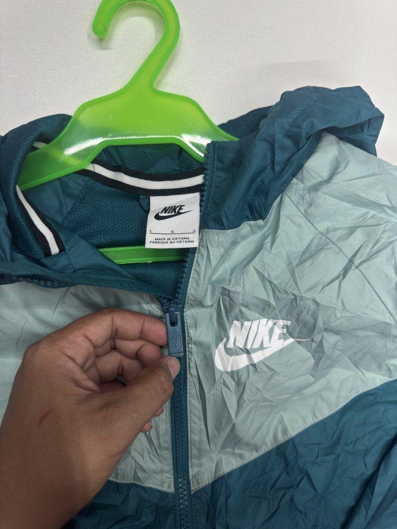 Nike Windrunner Jacket Teal Green Size L (Category: Coats, Jackets and Outerwear) located in Bustos. Submitted by thenlnclot60500 (Listing ID 1470632898, Image 2). Description: - Brand: Nike - Style: Windrunner Jacket - Color: Teal and Light Green - Size: Large - Style Number: 850443-381 - Condition: Brand new with tags attached - Material: 100% Polyester body and mesh lining - Features: Full zip closure, attached hood, and two zippered side pock