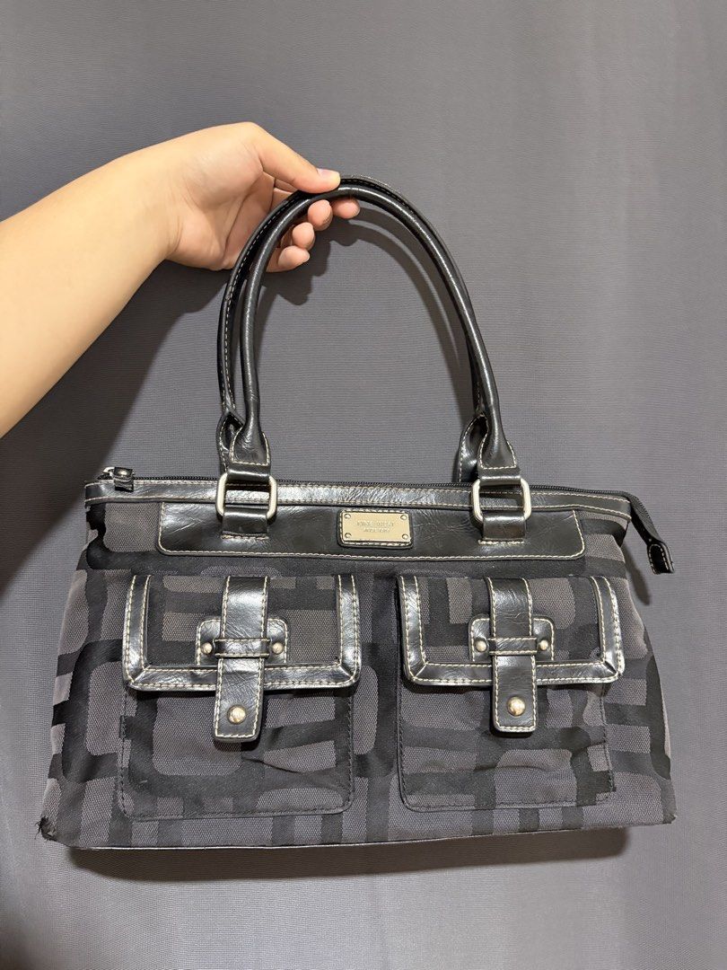 Nine West Monogram Shoulder Bag (Category: Shoulder Bags) located in Manila. Submitted by clever.heartfilia (Listing ID 1470563575, Image 1). Description: - Authentic Nine West shoulder bag in classic black and grey monogram print - Dual top handles and secure top-zip closure - Features two front pockets with stylish buckle strap closures and metal hardware - Accentuated with silver-tone brand plaque and contrast white stitching - Note: Shows vis