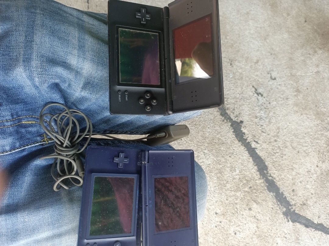Nintendo DS Lite Handheld Consoles Bundle (Category: Nintendo) located in Taguig. Submitted by grandfish_55ab5c (Listing ID 1470569391, Image 1). Description: - Nintendo DS Lite Console Bundle (Black and Ice Blue) - Blue unit features tape repairs near the hinge area - Both screens are fully functional - Includes 1 original AC adapter wall charger with cable - Batteries are included inside both units - Ideal for parts, repairs, or retro gaming pr