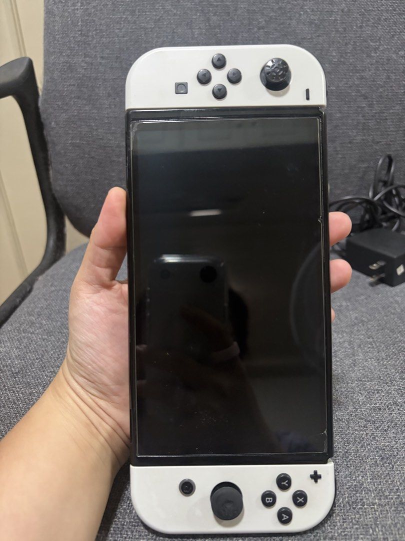 Nintendo Switch OLED Model White Console with Dock and Charger (Category: Nintendo) located in Las Pinas. Submitted by kindredcurations_2025 (Listing ID 1470560136, Image 2). Description: - Item: Nintendo Switch OLED Model (White) - Condition: Fully functional and tested, minor wear on screen - Inclusions: Original white dock, power adapter, and Joy-Con controllers - Usage: Ready for home or on-the-go gaming - Meetup and shipping options availabl