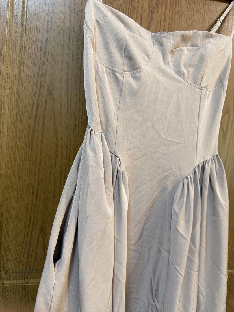 Nude spaghetti strap bustier midi dress with pockets (Category: Dresses) located in Makati City. Submitted by andzr. (Listing ID 1470647416, Image 2). Description: - Nude/taupe midi dress, easy to dress up or down - Structured bustier bodice with chic contrast stitching - Adjustable spaghetti straps and flexible smocked back panel - Gathered waistline with a flattering flared skirt - Comes with practical functional side pockets.