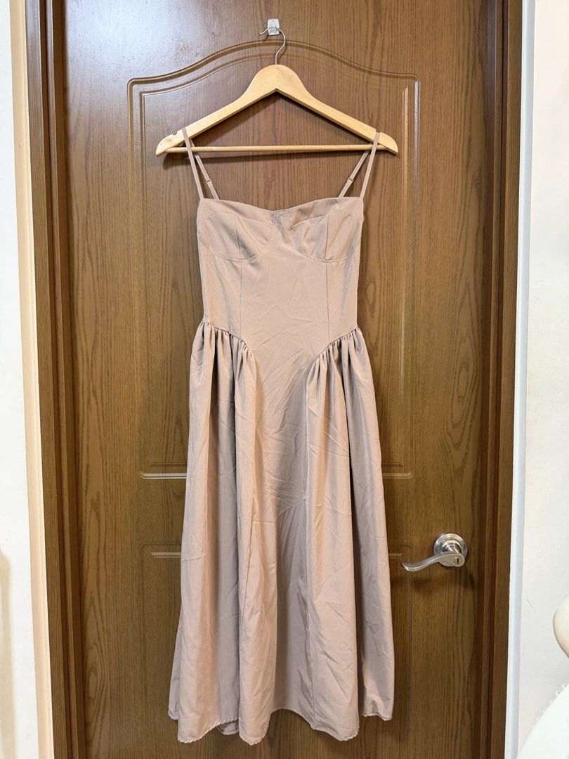 Nude spaghetti strap bustier midi dress with pockets (Category: Dresses) located in Makati City. Submitted by andzr. (Listing ID 1470647416, Image 1). Description: - Nude/taupe midi dress, easy to dress up or down - Structured bustier bodice with chic contrast stitching - Adjustable spaghetti straps and flexible smocked back panel - Gathered waistline with a flattering flared skirt - Comes with practical functional side pockets.