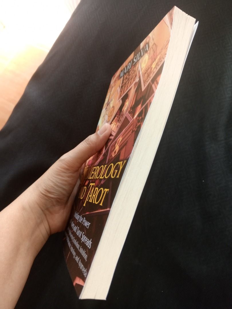 Numerology and Tarot by Mari Silva (Category: Storybooks) located in Pasig City. Submitted by booknhobs (Listing ID 1470620349, Image 3). Description: - Title: Two-in-One Divination Guide by Mari Silva - Topics: Numerology, tarot spreads, symbolism, intuition, astrology, ayurveda, numerological divination. - Format: Paperback edition - Condition: Like new, barely read, clean pages, and intact spine - Ideal For: Beginners and enthusiasts exploring