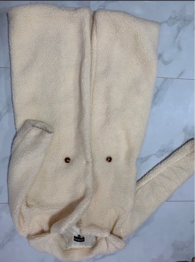 Off White Teddy Bear Coat (Category: Coats, Jackets and Outerwear) located in Manila. Submitted by decluterthings888 (Listing ID 1470560087, Image 1). Description: - Color: Off-white - Material: Super soft fleece with full lining - Style: Double-breasted with brown tortoiseshell buttons - Design: Wide lapel collar and long sleeves - Ideal for: Cozy and warm winter outerwear.