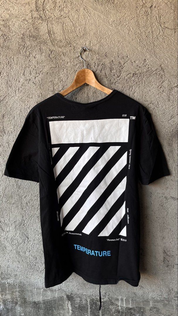 Off-White Temperature Black T-Shirt Spring-Summer 2018 (Category: Tshirts & Polo Shirts ) located in Cabuyao City. Submitted by bulandos (Listing ID 1470653354, Image 2). Description: Off-White Temperature black t-shirt from the Spring-Summer 2018 collection. Small Off logo on the chest, bold temperature graphics and diagonal stripes on the back. Blue temperature text accents. Classic crew neck short sleeve fit. Made in China, 100 percent cotton 
