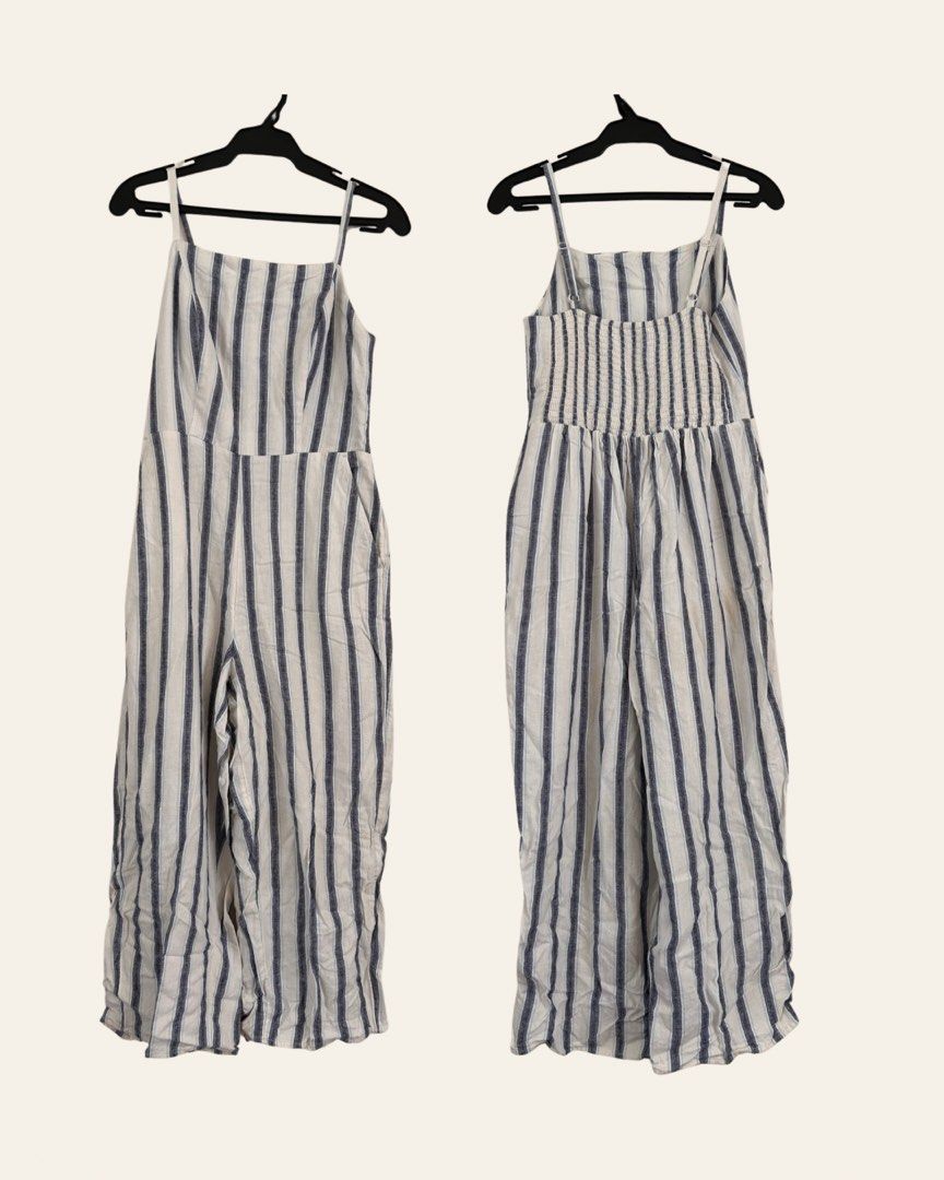 Old Navy Full-length Striped Romper Jumpsuit (Category: Jumpsuits) located in Paranaque City. Submitted by jackie.g (Listing ID 1470599598, Image 2). Description: - Brand: Old Navy - Style: Full-length romper with straight-leg trousers - Pattern: Vertical stripes (dark navy & cream) - Details: Square neckline, adjustable spaghetti straps, smocked back panel, and functional side pockets - Material: Lightweight fabric - Condition: Great other than 
