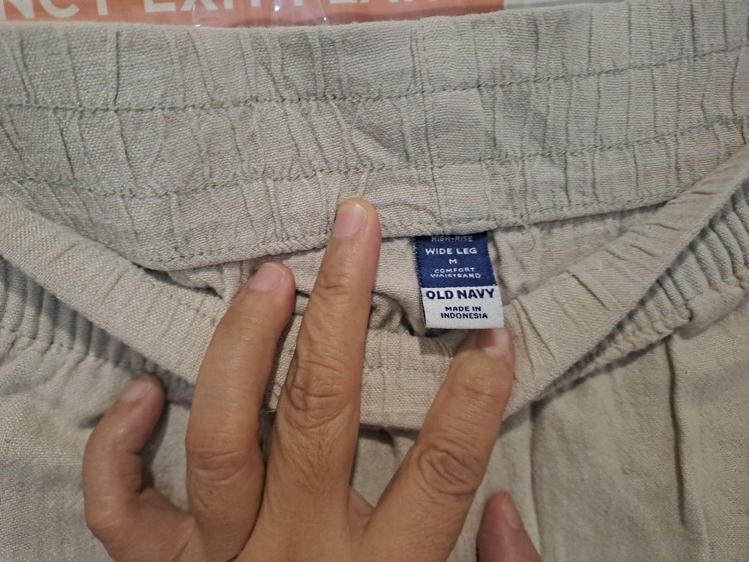 Old navy wide leg (Category: Other Bottoms) located in Manila. Submitted by joanbalde39643 (Listing ID 1470662052, Image 2). Description: The item in the image is a old navy pair of beige linen wide-leg cropped pants featuring an elastic smocked waistband, slip side pockets, and a casual frayed raw hem.