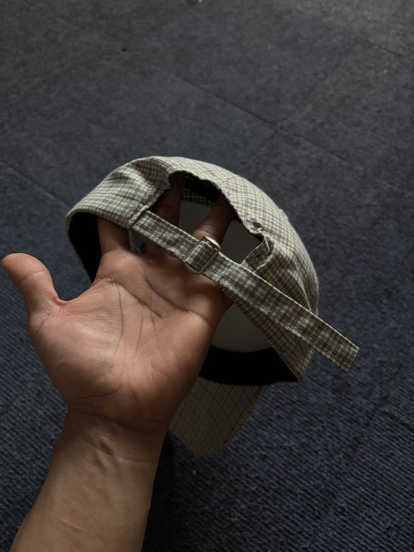 ONEIDEA Plaid Cap with Bear Embroidery (Category: Caps & Hats) located in Manila. Submitted by toys_hats005 (Listing ID 1470628397, Image 2). Description: - Brand: ONEIDEA - Design: Green and purple plaid pattern with front embroidered bear graphic and 'GOOD LUCK 1990' text - Structure: Structured panels with a curved brim - Fit: Adjustable strap back with metal slider for a custom fit - Details: Includes inner sweatband and original brand tags -