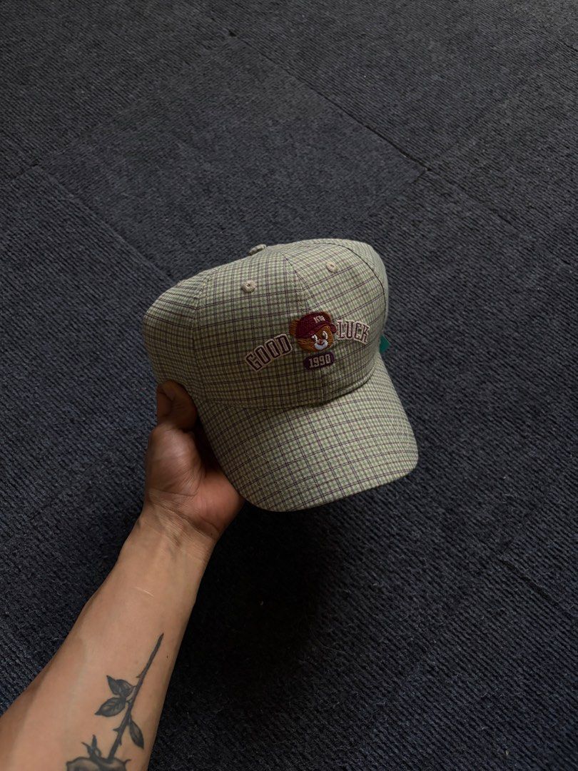 ONEIDEA Plaid Cap with Bear Embroidery (Category: Caps & Hats) located in Manila. Submitted by toys_hats005 (Listing ID 1470628397, Image 1). Description: - Brand: ONEIDEA - Design: Green and purple plaid pattern with front embroidered bear graphic and 'GOOD LUCK 1990' text - Structure: Structured panels with a curved brim - Fit: Adjustable strap back with metal slider for a custom fit - Details: Includes inner sweatband and original brand tags -