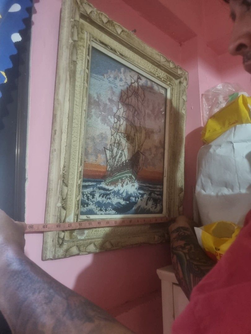 Original artwork featuring a figure holding a mask (Category: Art & Prints) located in Taguig. Submitted by grandfish_55ab5c (Listing ID 1470567468, Image 3). Description: - Type: Original handmade artwork on canvas - Artist: Signed by K. Nagamine - Design: Figure holding a red mask with abstract faces and elements - Color Palette: Muted tones of blue, green, and grey - Texture: Rough edges and visible texture from direct canvas painting - Condit