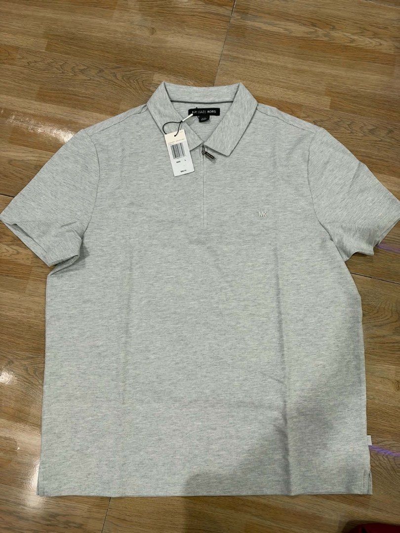 Original Michael Kors Grey Zip Polo Shirt (Category: Tshirts & Polo Shirts ) located in Apalit. Submitted by brandednewprebycharie (Listing ID 1470692317, Image 2). Description: - Brand: Michael Kors - Item: Men's Short-Sleeve Polo Shirt - Color: Light Grey - Fit: Regular Fit - Condition: Brand new with original tags attached (unworn) - Details: Modern half-zip placket and embroidered MK chest logo - Perfect for smart-casual wear, office, or week