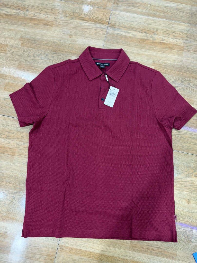 Original Michael Kors Maroon Polo Shirt (Category: Tshirts & Polo Shirts ) located in Apalit. Submitted by brandednewprebycharie (Listing ID 1470689661, Image 1). Description: - Brand: Michael Kors - Color: Maroon / Deep Burgundy - Material: Textured cotton - Fit: Regular fit with short sleeves and classic collar - Condition: Brand new with original retail tags attached - Perfect for casual outings and easy to pair with jeans or chinos.