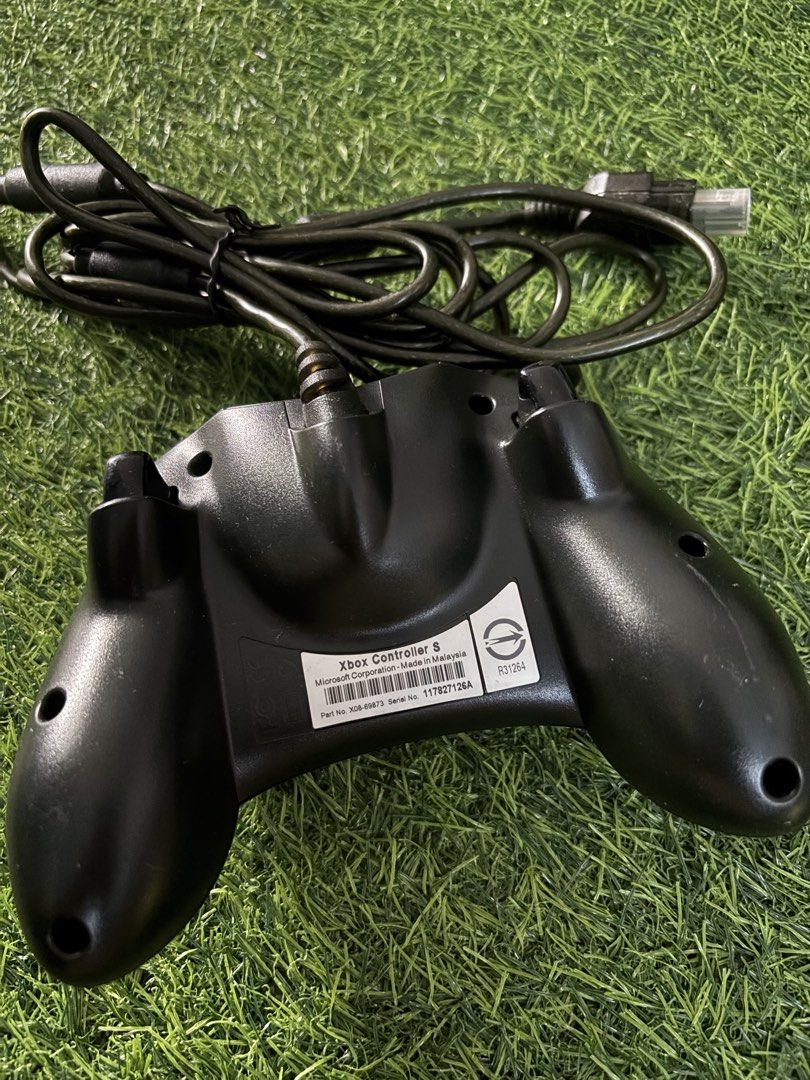 Original Microsoft Xbox Controller S Black (Category: Controllers) located in Makati City. Submitted by rare_thrift_stuff (Listing ID 1470612753, Image 2). Description: - Genuine Microsoft Xbox Controller S in classic black - Includes wired setup with original breakaway cable - Features standard thumbsticks, D-pad, and action buttons - Made in Malaysia with serial number sticker intact on the back - Fully compatible with the original Xbox console