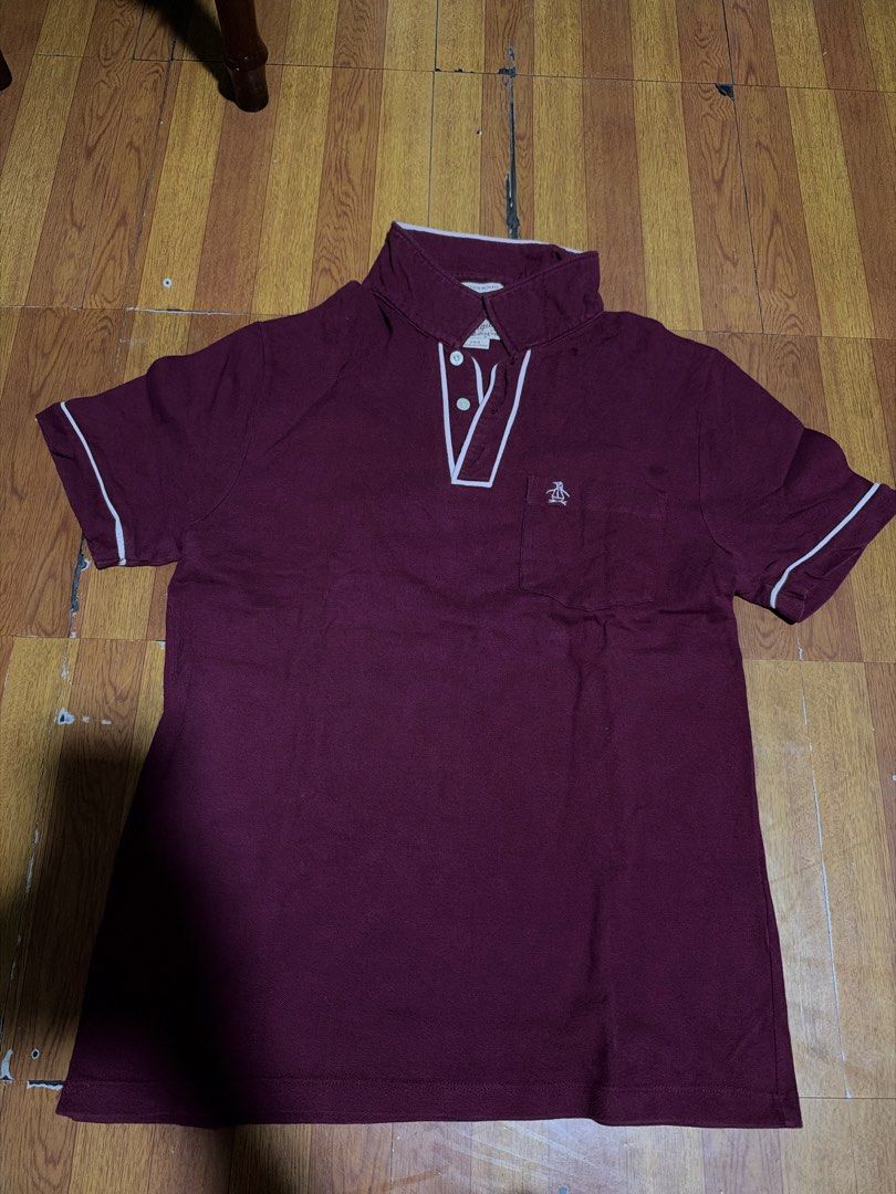 Original Penguin Maroon Polo Shirt (Category: Tshirts & Polo Shirts ) located in Manila. Submitted by annabananna (Listing ID 1470685691, Image 1). Description: - Brand: Original Penguin - Color: Maroon with contrasting white trim on collar, placket, and sleeve cuffs - Details: Left chest pocket with embroidered penguin logo, 3 white front buttons - Style: Classic short sleeve, comfortable everyday wear - Condition: Clean, well-maintained.