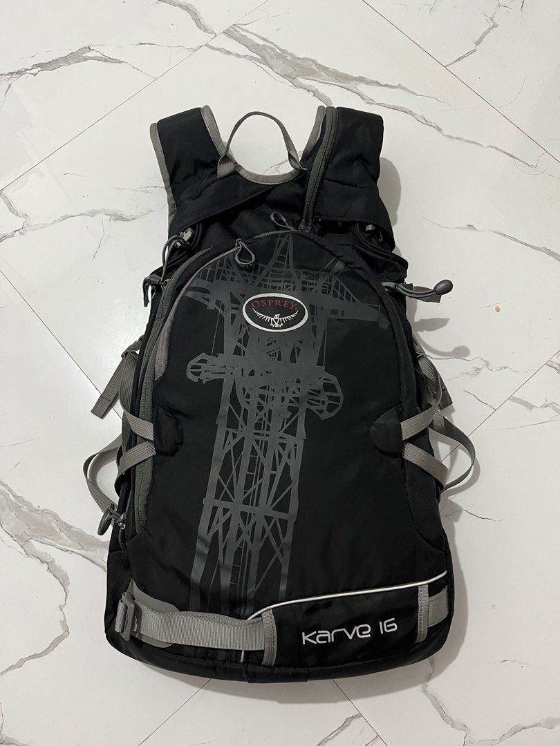 Osprey Karve 16 Black Backpack (Category: Backpacks) located in Manila. Submitted by obedmagall74424 (Listing ID 1470613187, Image 1). Description: - Brand/Model: Osprey Karve 16 Daypack - Color: Black with grey accents and front pocket graphic tower print - Comfort & Fit: Padded back panel, ergonomic shoulder straps, and multiple adjustment straps - Features: Hydration tube port included - Origin: Made in Vietnam - Condition: Clean interior and 