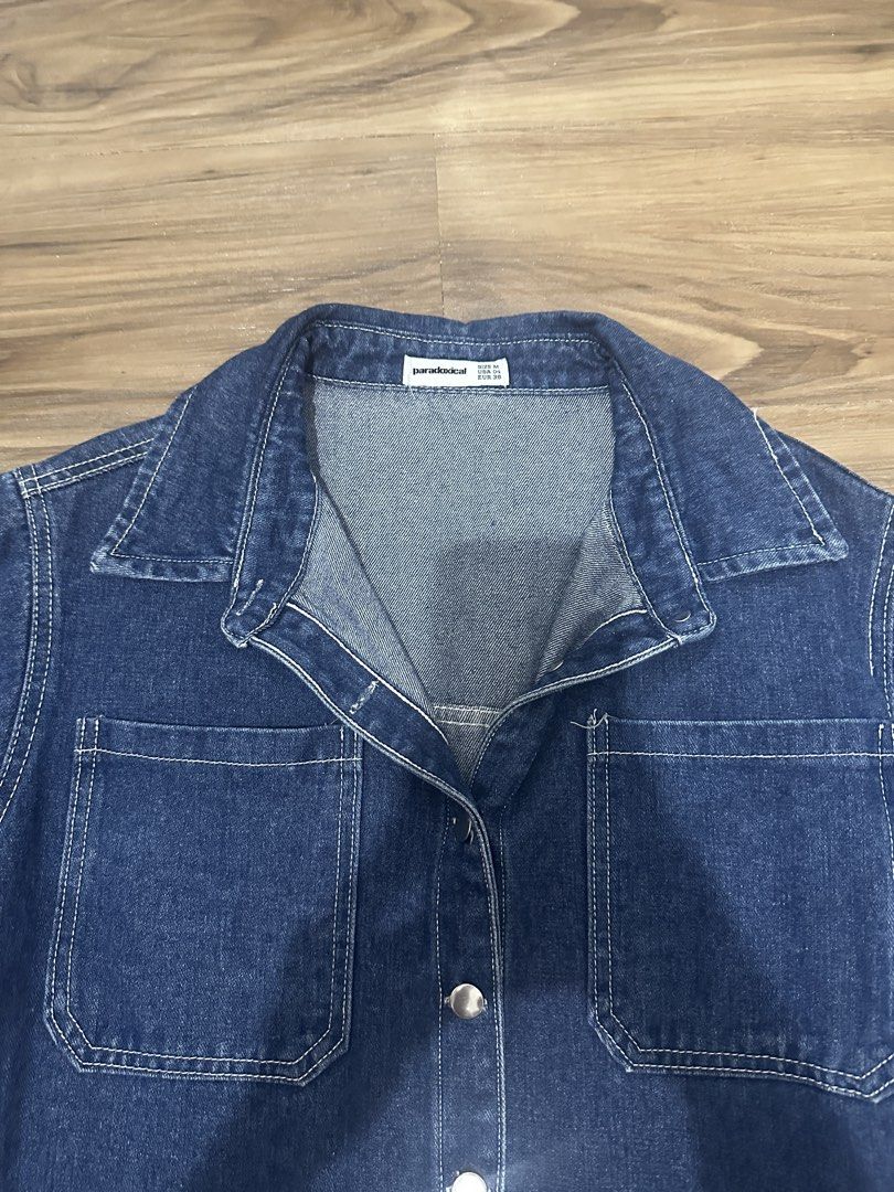 Paradoxical Denim Short Sleeve Button Up Shirt (Category: Shirts) located in Paranaque City. Submitted by declutterwyae (Listing ID 1470645823, Image 2). Description: - Brand: Paradoxical - Color: Dark blue wash with white contrast stitching - Style: Short sleeve denim shirt, collared neck, front button closure - Features: Two functional chest pockets - Size: Medium (USA 04, EUR 38) - Condition: Clean, well-maintained.