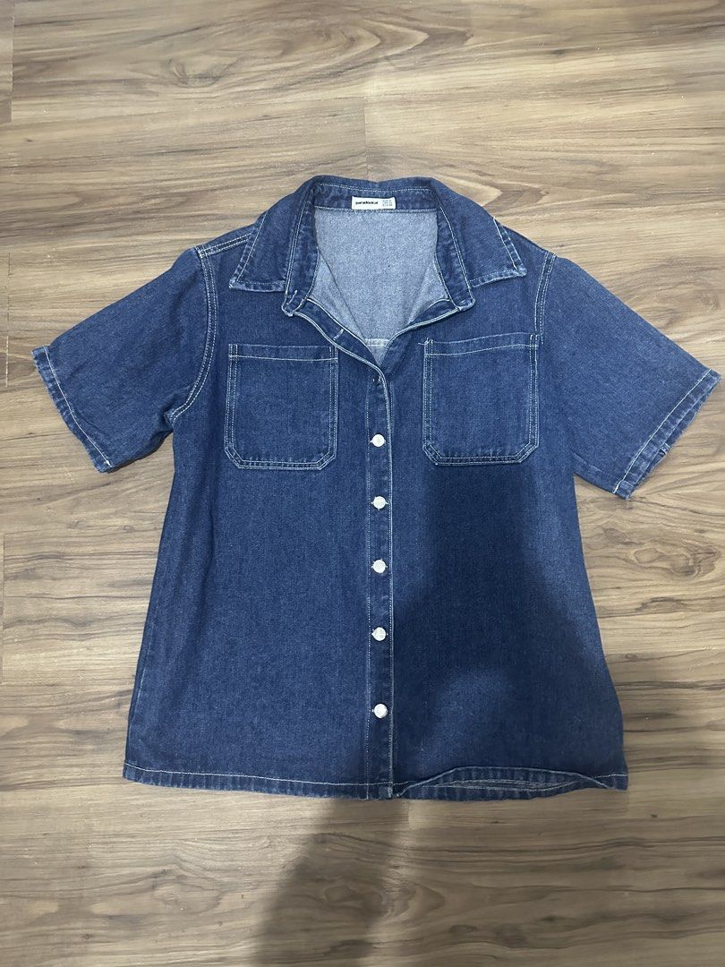Paradoxical Denim Short Sleeve Button Up Shirt (Category: Shirts) located in Paranaque City. Submitted by declutterwyae (Listing ID 1470645823, Image 1). Description: - Brand: Paradoxical - Color: Dark blue wash with white contrast stitching - Style: Short sleeve denim shirt, collared neck, front button closure - Features: Two functional chest pockets - Size: Medium (USA 04, EUR 38) - Condition: Clean, well-maintained.