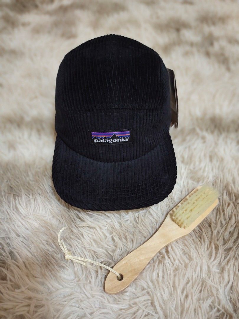 Patagonia 5panel Black Corduroy Cap Hat (Category: Caps & Hats) located in Manila. Submitted by jomss05 (Listing ID 1470694389, Image 1). Description: - Brand: Patagonia - Material: Soft black corduroy with tags still attached - Design: Classic 5-panel shape with front logo patch - Condition: Brand new, ready to wear - Bonus: Includes a small wooden brush for easy cleaning and maintenance.