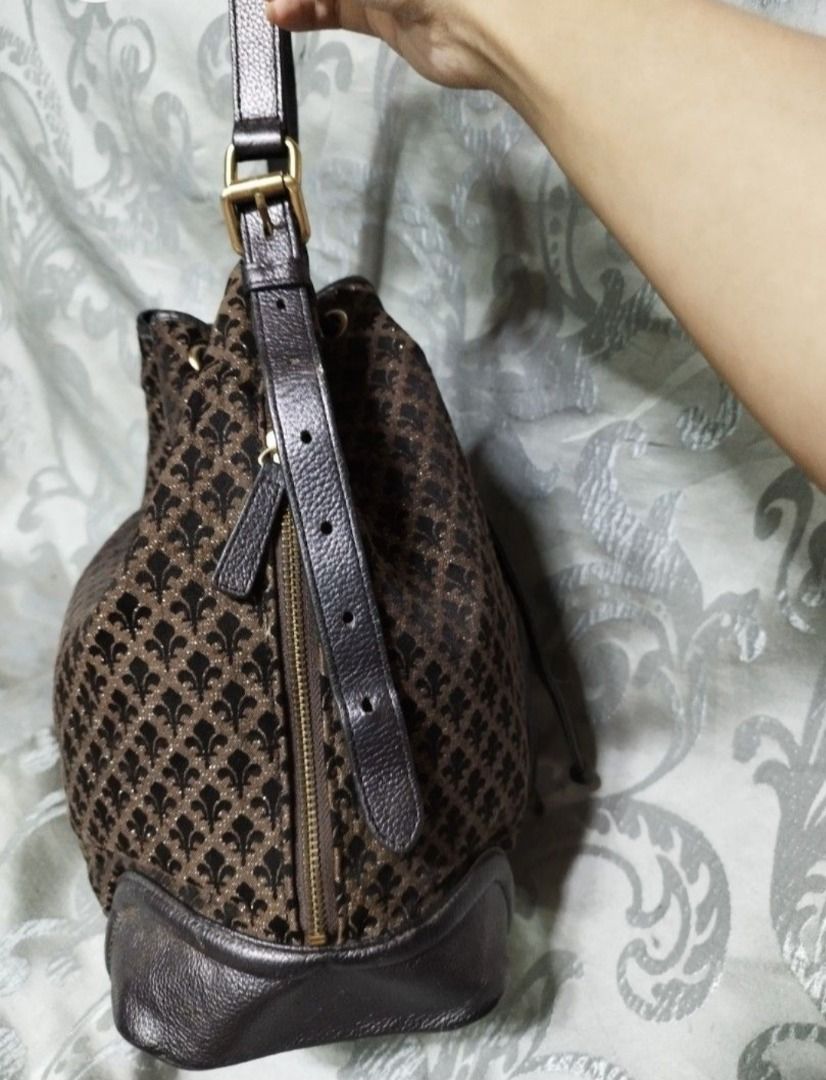 Patrick Cox Brown Monogram Bucket Bag with Drawstring (Category: Luxury Bags & Wallets) located in Manila. Submitted by axelyuna.27 (Listing ID 1470573917, Image 3). Description: Authentic Patrick Cox bucket bag in brown patterned fabric with dark brown leather trim. Features a secure drawstring closure, adjustable strap, gold-tone hardware, and a handy side zipper. Stylish and functional for everyday use!.