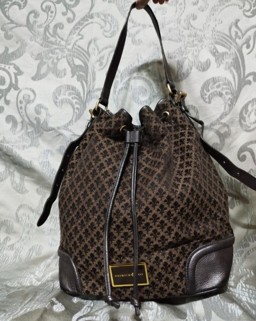 Patrick Cox Brown Monogram Bucket Bag with Drawstring (Category: Luxury Bags & Wallets) located in Manila. Submitted by axelyuna.27 (Listing ID 1470573917, Image 1). Description: Authentic Patrick Cox bucket bag in brown patterned fabric with dark brown leather trim. Features a secure drawstring closure, adjustable strap, gold-tone hardware, and a handy side zipper. Stylish and functional for everyday use!.