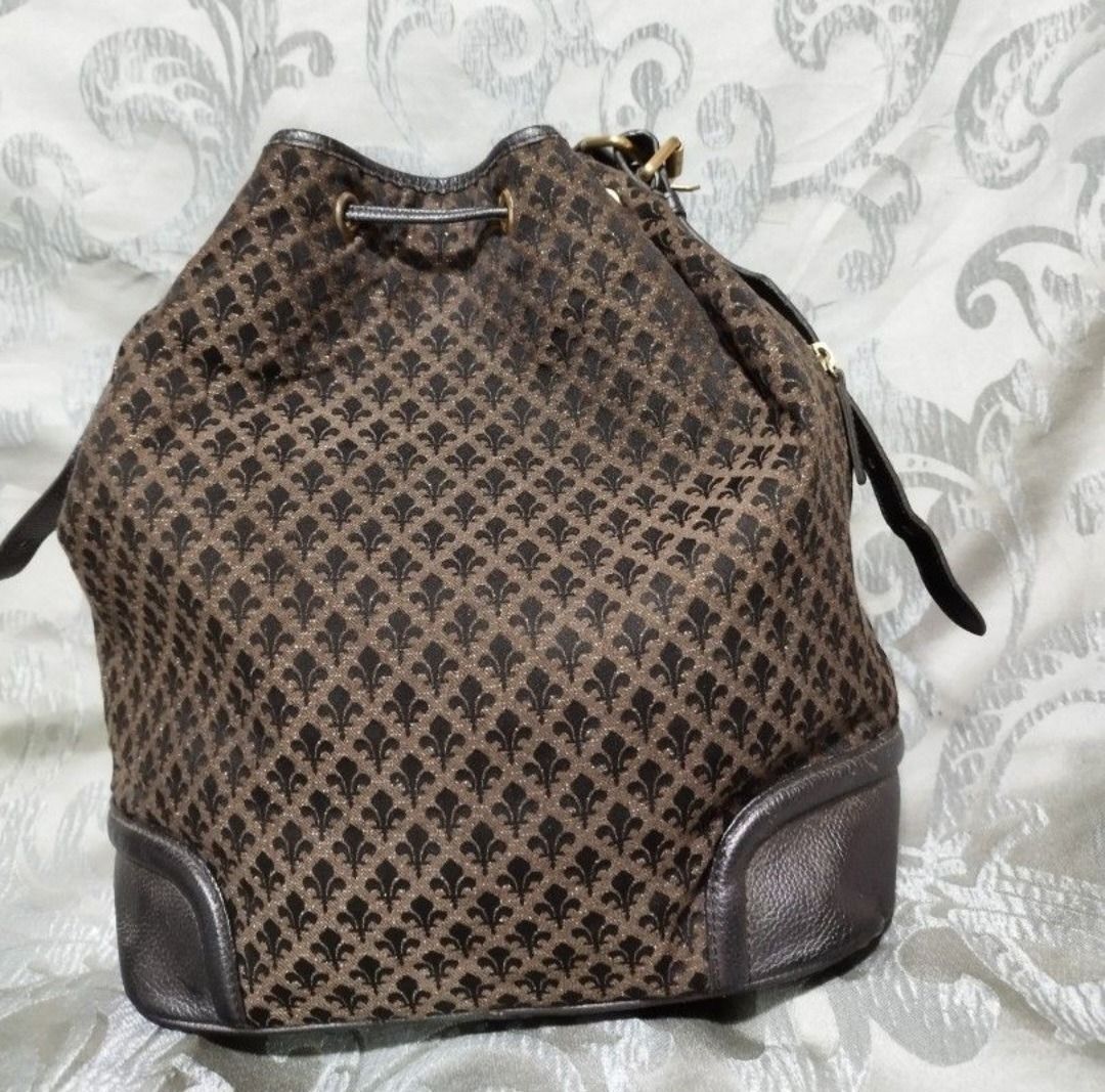 Patrick Cox Brown Monogram Bucket Bag with Drawstring (Category: Luxury Bags & Wallets) located in Manila. Submitted by axelyuna.27 (Listing ID 1470573917, Image 2). Description: Authentic Patrick Cox bucket bag in brown patterned fabric with dark brown leather trim. Features a secure drawstring closure, adjustable strap, gold-tone hardware, and a handy side zipper. Stylish and functional for everyday use!.