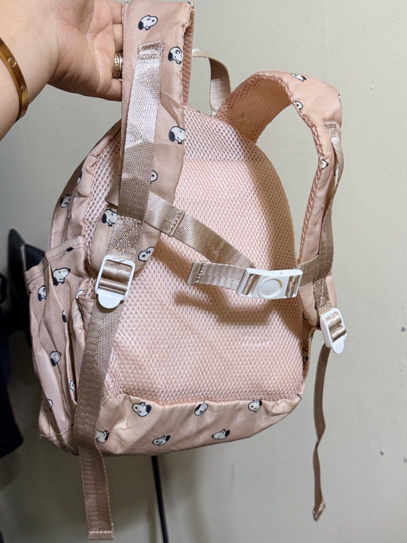 Peanuts Snoopy Pink All-Over Print Mini Backpack (Category: Backpacks) located in Paete. Submitted by skydruemadison (Listing ID 1470684400, Image 2). Description: - Authentic 2020 Peanuts Worldwide merchandise - Adorable all-over Snoopy face pattern in pink - Lightweight and durable nylon material - Features a secure front zip pocket and main compartment with interior slip pocket - Adjustable shoulder straps with a chest buckle clip for extra co