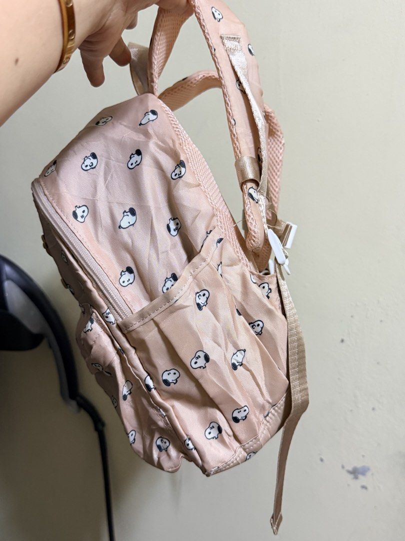Peanuts Snoopy Pink All-Over Print Mini Backpack (Category: Backpacks) located in Paete. Submitted by skydruemadison (Listing ID 1470684400, Image 3). Description: - Authentic 2020 Peanuts Worldwide merchandise - Adorable all-over Snoopy face pattern in pink - Lightweight and durable nylon material - Features a secure front zip pocket and main compartment with interior slip pocket - Adjustable shoulder straps with a chest buckle clip for extra co