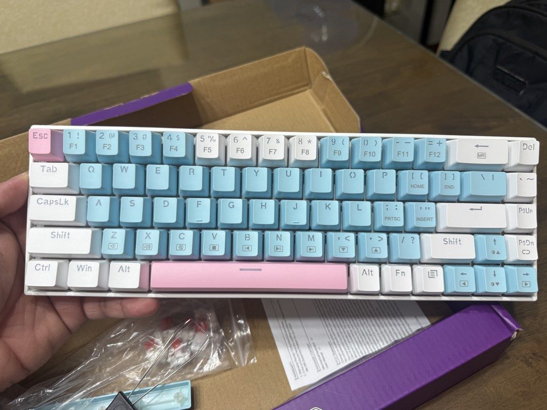 Persona GKW202 Mechanical Keyboard (Category: Computer Keyboard) located in Quezon City. Submitted by hanzpascua (Listing ID 1470674873, Image 3). Description: - Model: Persona GKW202 Mechanical Keyboard - Layout: Compact 60% layout to save desk space - Switches: Mechanical red switches for smooth typing and gaming - Aesthetic: White, blue, and pink colorway with backlight illumination - In-Box Extras: Spare switches, keycap puller, alternate spa